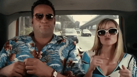 Animated GIF of two people in Hawaiian shirts riding in a car