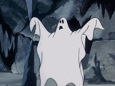 Animated cartoon of a startled white ghost floating in a cave